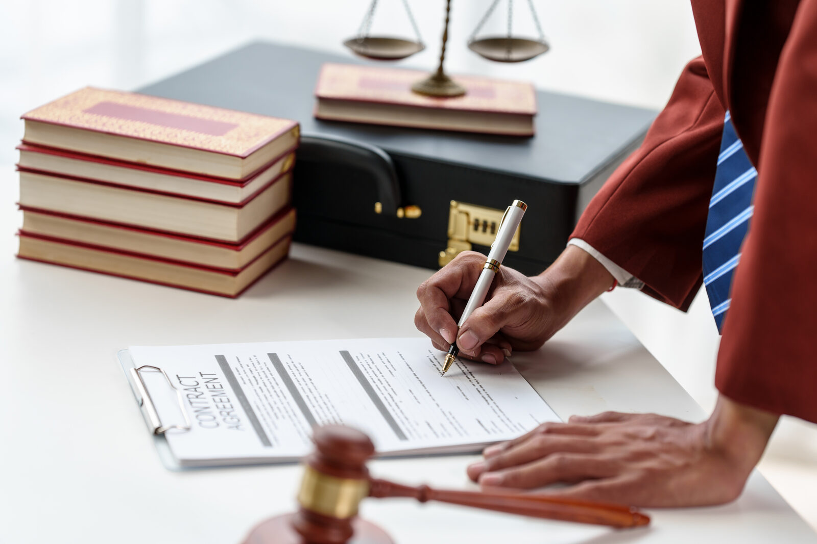 Close-up of hands reviewing a printed contract on a desk